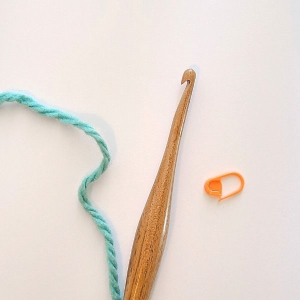 Image showing yarn, hook and stitch marker - Tools you'll need to work the crochet moss stitch.