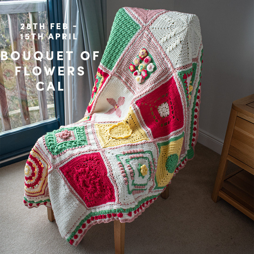 This image shows the finished product of the Bouquet of Flowers Afghan CAL, as created by Sunflower Cottage crochet. The afghan is shown draped over a chair with a window in the background.