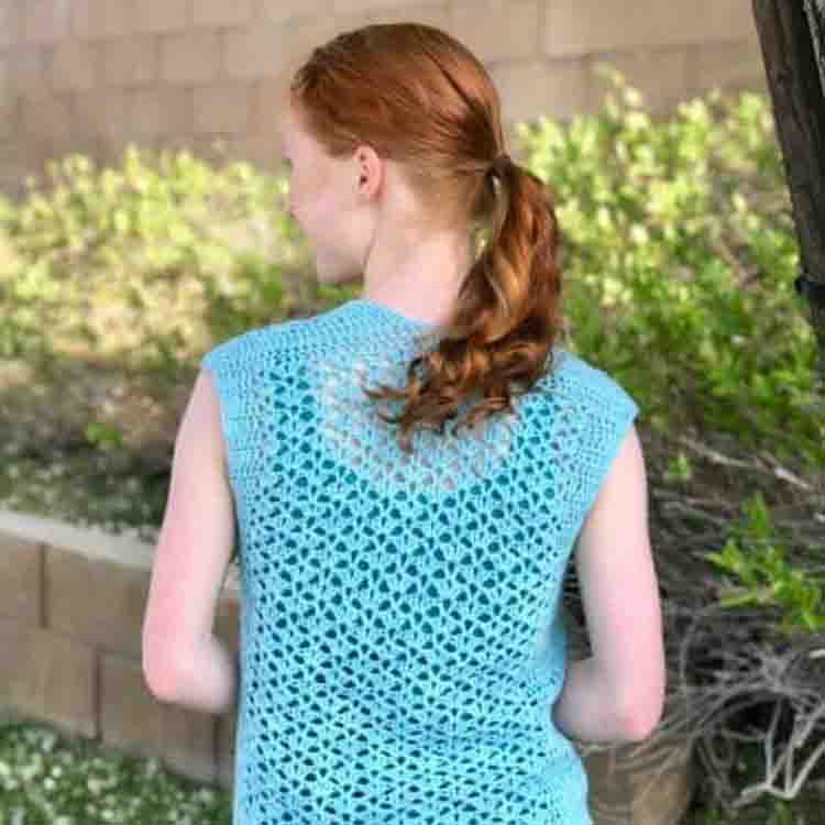This image shows a woman wearing the Summer Breeze Vest. She is standing with her back facing us so you can see the texture of the vest.