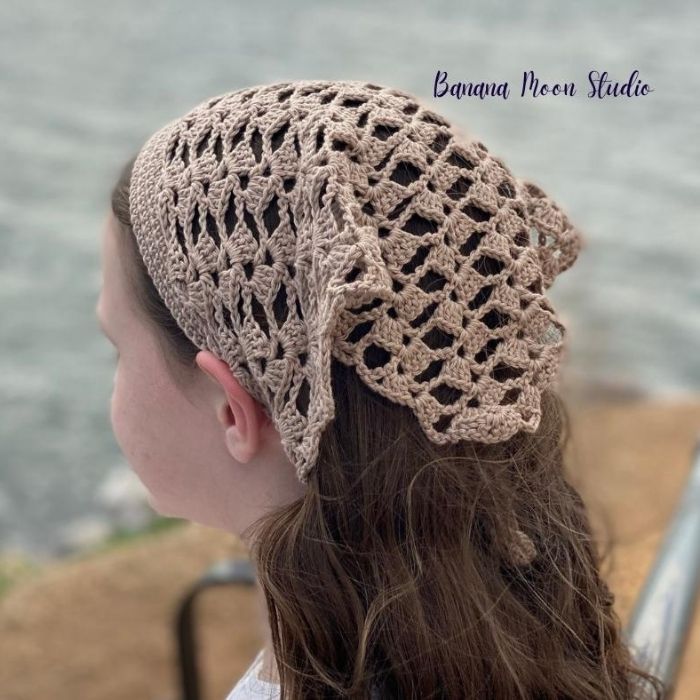 This image shows the Marietta Kerchief, one of the crochet projects for summer, worn by a young girl. The image is taken from behind so you can see the texture of the lace kerchief.