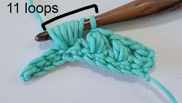 This image shows the first steps to working a 5 hdc crochet puff stitch as specified in the text.