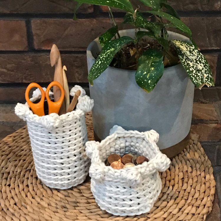 This image shows the next pattern, which is the Simple Bobble Baskets as described above. The image shows the baskets next to a planter, with coins in the smaller basket and crochet hooks in the larger basket.