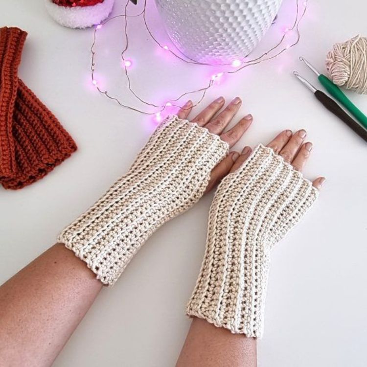This image shows the next pattern which is the Ridged Crochet Fingerless Gloves as described above. The image shows the gloves being worn, with the hands of the model laying flat on a white background.