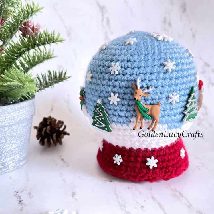 This image shows the next quick pattern, which is the Snow Globe as described above. The image shows the snow globe on a marble background, with a faux Christmas plant to the side.