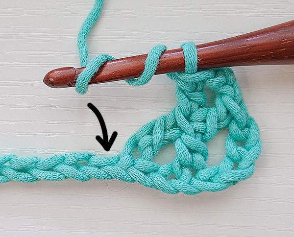 This image shows the next step in working a Crossed Treble Crochet or K Stitch, as detailed in the text.